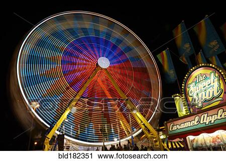 Blurred view of ferris wheel at amusement park View Large Photo Image Stock Image - Blurred view of ferris wheel at amusement park. Fotosearch