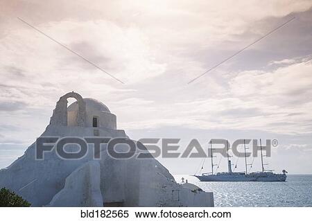 Boat sailing near traditional building View Large Photo Image Stock Photography - Boat sailing near traditional building. Fotosearch