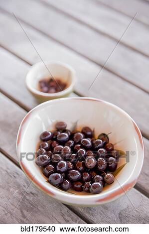 Stock Image - Bowl of olives on table. Fotosearch