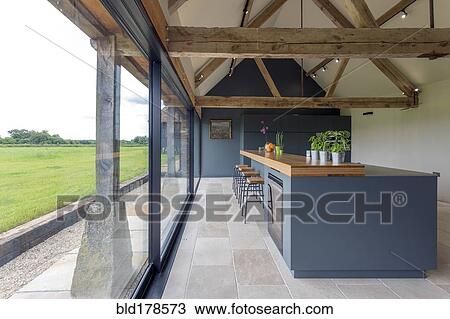 Breakfast bar and glass wall in modern kitchen View Large Photo Image Stock Image - Breakfast bar and glass wall in modern kitchen. Fotosearch