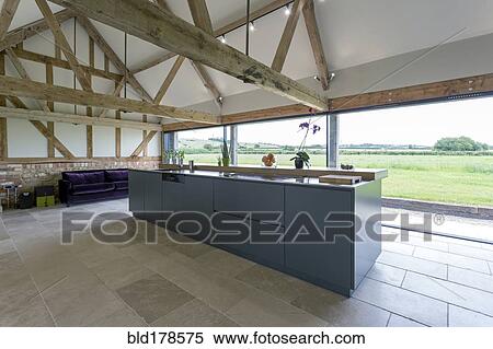 Stock Photography - Breakfast bar and glass wall in modern kitchen. Fotosearch