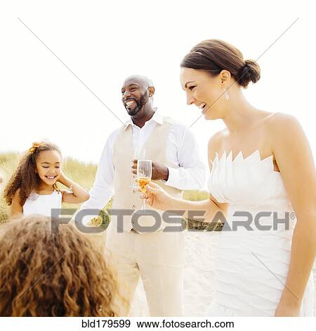 Bride and groom celebrating with flower girl daughters View Large Photo Image Stock Photo - Bride and groom celebrating with flower girl daughters. Fotosearch