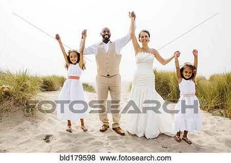 Bride and groom cheering with flower girl daughters View Large Photo Image Stock Photo - Bride and groom cheering with flower girl daughters. Fotosearch