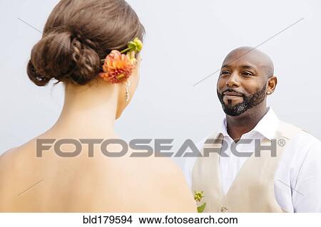Bride and groom standing outdoors View Large Photo Image Picture - Bride and groom standing outdoors. Fotosearch