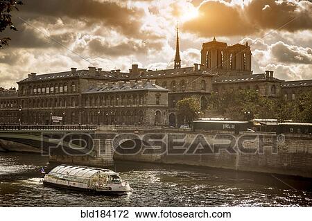 Stock Image - Buildings and bridge over river in Paris, Ile-de-France, France. Fotosearch