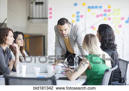 Business people talking in office meeting View Large Photo Image Stock Image - Business people talking in office meeting. Fotosearch