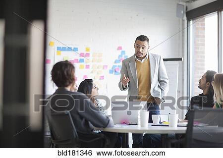 Stock Photograph - Business people talking in office meeting. Fotosearch