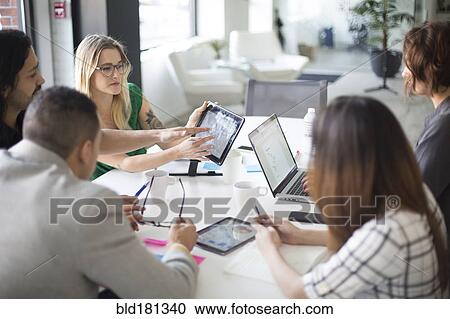 Business people using digital tablet in office meeting View Large Photo Image Stock Image - Business people using digital tablet in office meeting. Fotosearch