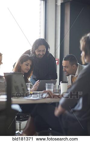 Business people using digital tablet in office View Large Photo Image Stock Image - Business people using digital tablet in office. Fotosearch