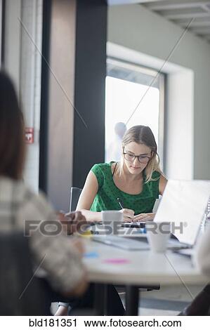 Stock Image - Business people working in office meeting. Fotosearch