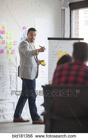Stock Photograph - Businessman talking in office meeting. Fotosearch