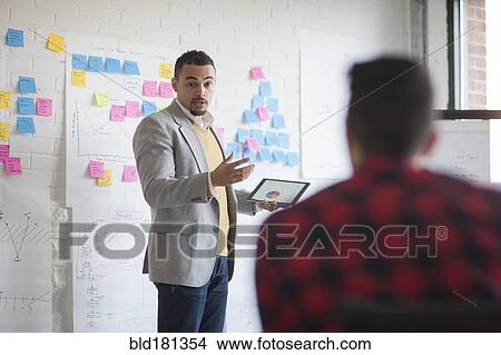 Picture - Businessmen talking in office meeting. Fotosearch