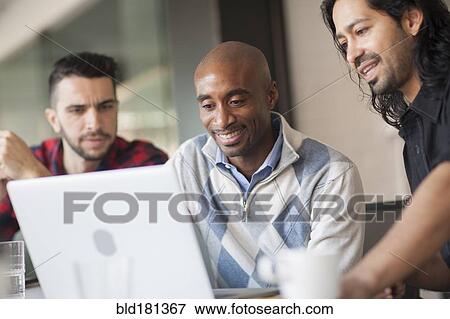 Businessmen using laptop in office View Large Photo Image Stock Photo - Businessmen using laptop in office. Fotosearch