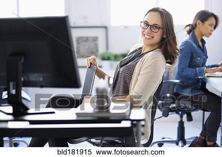 Stock Photography - Businesswoman smiling in office. Fotosearch