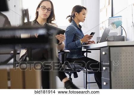 Businesswoman using digital tablet in office View Large Photo Image Picture - Businesswoman using digital tablet in office. Fotosearch