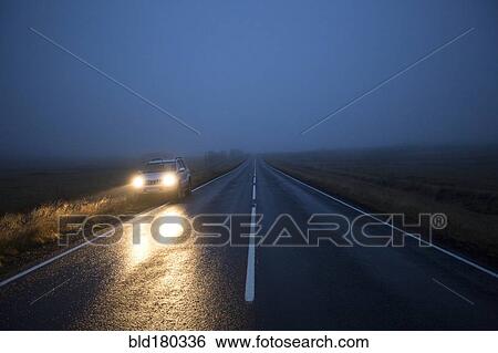 Stock Photograph - Car on remote road at night. Fotosearch