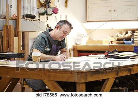 Carpenter sketching in workshop View Large Photo Image Stock Photography - Carpenter sketching in workshop. Fotosearch