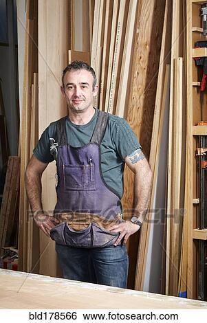 Carpenter smiling in workshop View Large Photo Image Stock Photograph - Carpenter smiling in workshop. Fotosearch