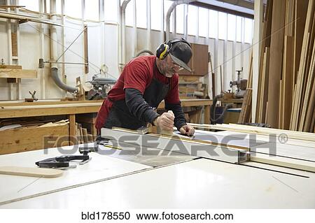 Carpenter using table saw in workshop View Large Photo Image Stock Image - Carpenter using table saw in workshop. Fotosearch