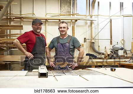 Carpenters smiling in workshop View Large Photo Image Stock Image - Carpenters smiling in workshop. Fotosearch