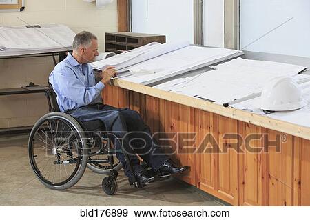 Caucasian architect in wheelchair working in office View Large Photo Image Stock Photo - Caucasian architect in wheelchair working in office. Fotosearch