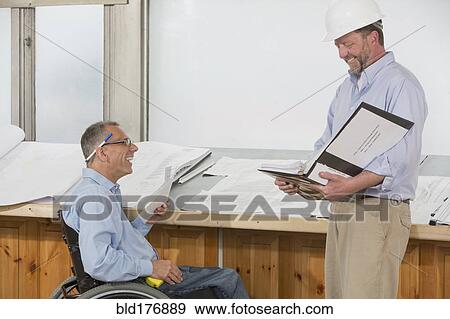Stock Photo - Caucasian architects talking in office. Fotosearch