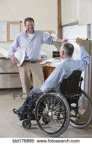 Stock Photography - Caucasian architects talking in office. Fotosearch