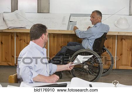 Stock Image - Caucasian architects working in office. Fotosearch