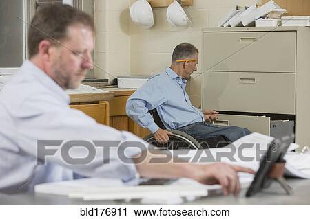 Stock Image - Caucasian architects working in office. Fotosearch