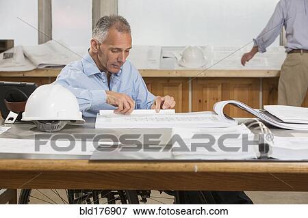 Stock Photo - Caucasian architects working in office. Fotosearch
