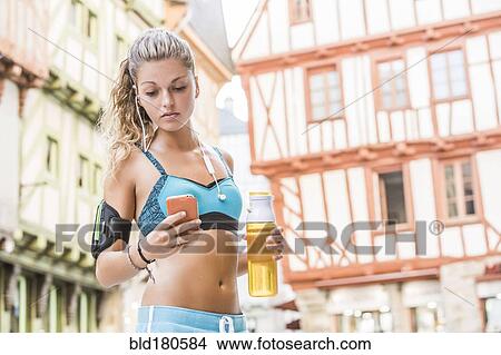 Caucasian athlete using cell phone outdoors View Large Photo Image Picture - Caucasian athlete using cell phone outdoors. Fotosearch