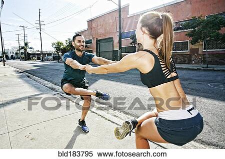 Caucasian athletes balancing on sidewalk View Large Photo Image Stock Photography - Caucasian athletes balancing on sidewalk. Fotosearch