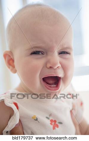 Stock Photo - Caucasian baby girl crying. Fotosearch
