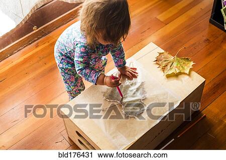 Caucasian baby girl drawing on leaf View Large Photo Image Stock Image - Caucasian baby girl drawing on leaf. Fotosearch