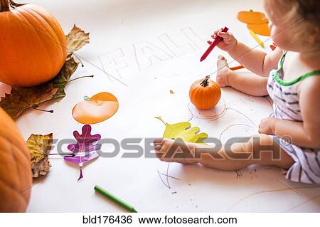 Stock Photograph - Caucasian baby girl drawing with crayon. Fotosearch