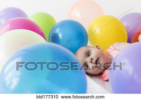 Caucasian baby girl laying in balloons View Large Photo Image Stock Image - Caucasian baby girl laying in balloons. Fotosearch