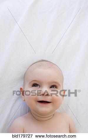 Caucasian baby girl laying on blanket View Large Photo Image Stock Photo - Caucasian baby girl laying on blanket. Fotosearch