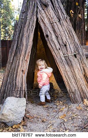 Caucasian baby girl playing in teepee View Large Photo Image Stock Photo - Caucasian baby girl playing in teepee. Fotosearch