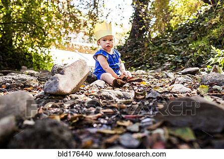 Caucasian baby girl sitting in grass View Large Photo Image Stock Image - Caucasian baby girl sitting in grass. Fotosearch