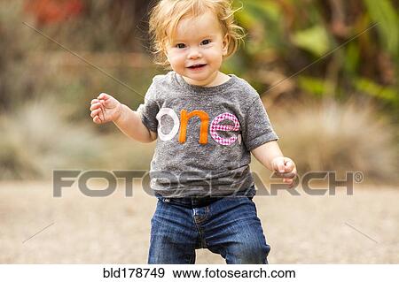 Caucasian baby girl walking outdoors View Large Photo Image Stock Photo - Caucasian baby girl walking outdoors. Fotosearch