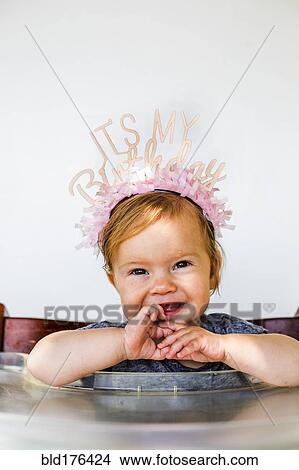 Caucasian baby girl wearing birthday crown View Large Photo Image Picture - Caucasian baby girl wearing birthday crown. Fotosearch