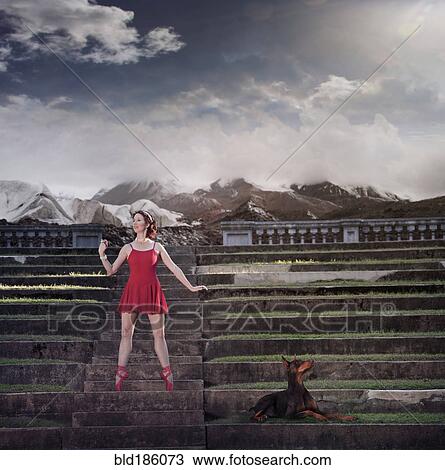 Stock Image - Caucasian ballet dancer balancing on ruins. Fotosearch