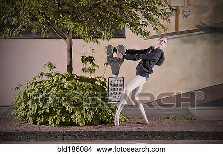Picture - Caucasian ballet dancer posing with parking meter. Fotosearch
