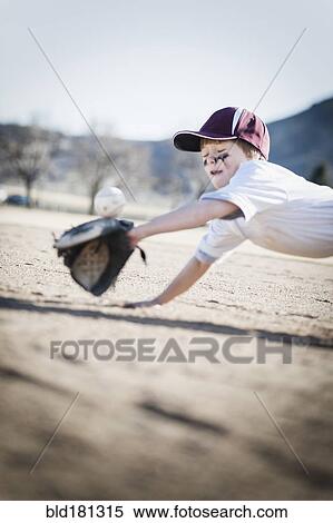 Caucasian boy catching baseball on field View Large Photo Image Stock Photography - Caucasian boy catching baseball on field. Fotosearch