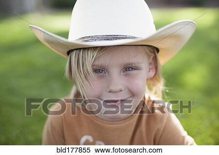 Stock Photography - Caucasian boy in cowboy hat. Fotosearch