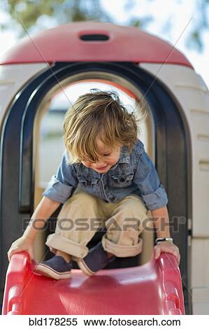 Stock Photography - Caucasian boy playing at playground. Fotosearch