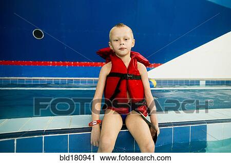 Caucasian boy wearing lifejacket at swimming pool View Large Photo Image Stock Image - Caucasian boy wearing lifejacket at swimming pool. Fotosearch