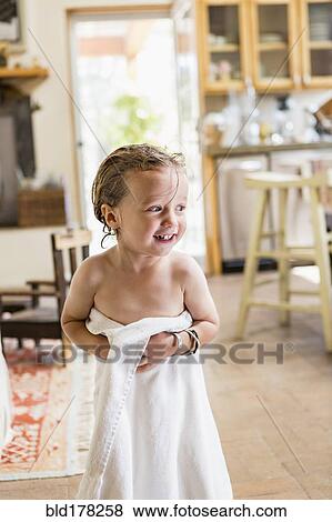 Stock Photo - Caucasian boy wrapped in towel. Fotosearch