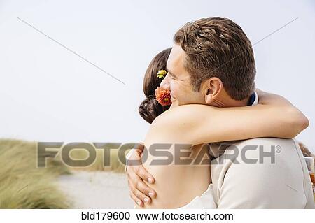 Caucasian bride and groom hugging in outdoor wedding View Large Photo Image Stock Image - Caucasian bride and groom hugging in outdoor wedding. Fotosearch