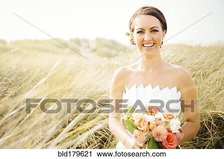 Caucasian bride standing in grass View Large Photo Image Stock Image - Caucasian bride standing in grass. Fotosearch
